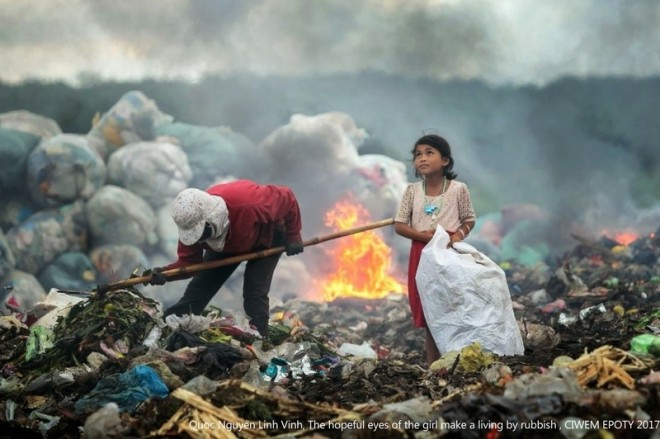 girl in rubbish award winning environment photography by quoc nguyen